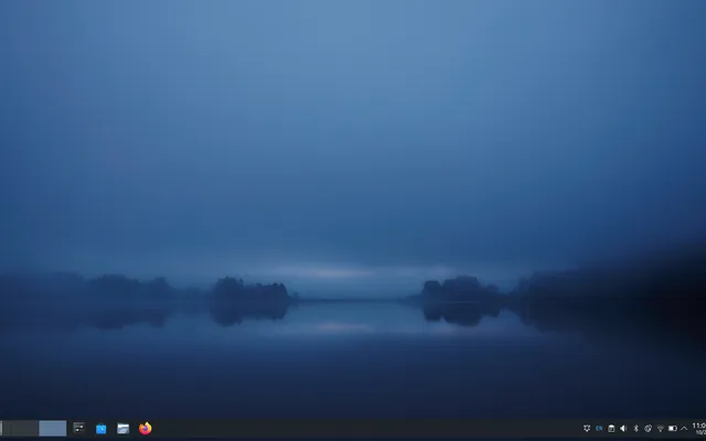Fedora KDE on the ThinkPad with a dark blue lake wallpaper and a compact bottom panel